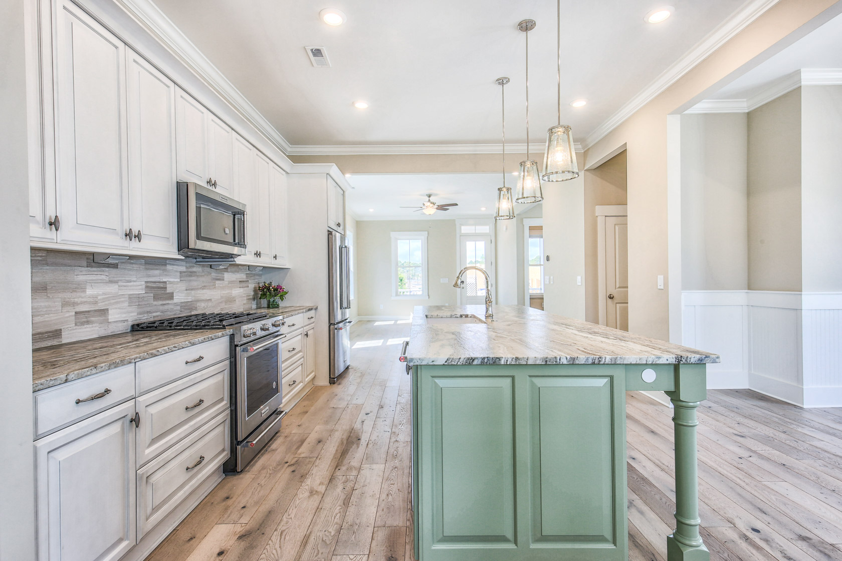 seafoam kitchen island and leather granite countertops in a low country style home
